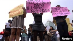 Women wearing miniskirts and tight leggings hold posters to protest against the idea that provocatively dressed women are to blame for sexual assaults, Jakarta, Indonesia (September 2011 File) 
