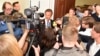 Julian Assange's lawyer Tomas Olsson, center, talks to media prior to a public court hearing in Stockholm, Sweden, July 16, 2014. 