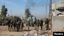 Iraqi rapid response forces gather during a fight with Islamic State militants in Intisar district of eastern Mosul, Iraq, Dec. 22, 2016. 