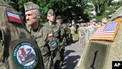 FILE - Polish Army and U.S. Army soldiers attend the opening ceremony of the Anaconda-16 military exercise, in Warsaw, Poland, June 6, 2016.