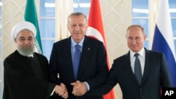 From left: Iranian President Hassan Rouhani, Turkish President Recep Tayyip Erdogan and Russian President Vladimir Putin shake hands during their meeting in Ankara, Turkey, Sept. 16, 2019.