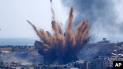 Smoke rises following Israeli airstrikes on a building in Gaza City. Palestinians are somberly marking the end of the Muslim holy month of Ramadan, as Hamas and Israel traded more rockets and airstrikes. 