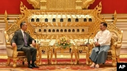 Chinese Foreign Minister Wang Yi, left, talks with Myanmar's military leader, Senior General Min Aung Hlaing, right, during their meeting on Aug. 14, 2024, in Naypyitaw, Myanmar. (Myanmar Military Information Team via AP)