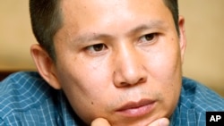 FILE - This July 17, 2009 file photo shows legal scholar Xu Zhiyong at a meeting in Beijing, China.