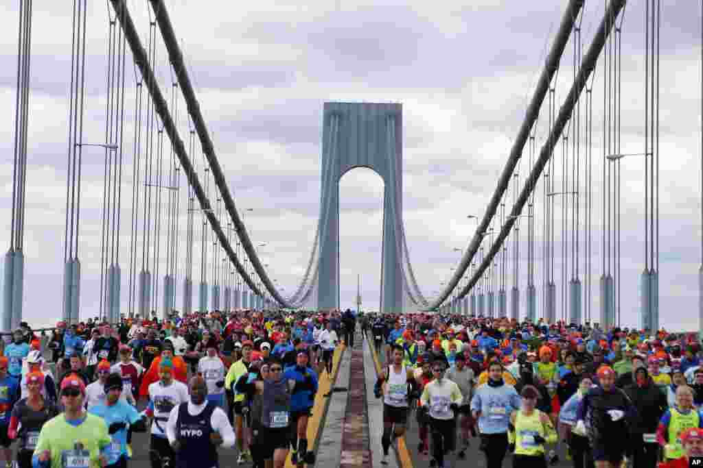 Runners cross the Verrazano-Narrows Bridge at the start of the New York City Marathon, Nov. 2, 2014, in New York.