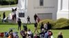 FILE - People picnic, play and walk at Peace Arch Park in Blaine, Washington, May 17, 2020. As Father's Day is observed in the United States June 21, 2020, many corovavirus restrictions have been eased in some areas of the country.