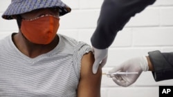 A volunteer receives a COVID-19 test vaccine injection developed at the University of Oxford in Britain, at the Chris Hani Baragwanath hospital in Soweto, Johannesburg, South Africa, June 24, 2020.
