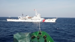 FILE PHOTO: A ship (top) of the Chinese Coast Guard is seen near a ship of the Vietnam Marine Guard in the South China Sea, about 210 km (130 miles) off shore of Vietnam May 14, 2014. REUTERS/Nguyen Minh/File Photo/File Photo