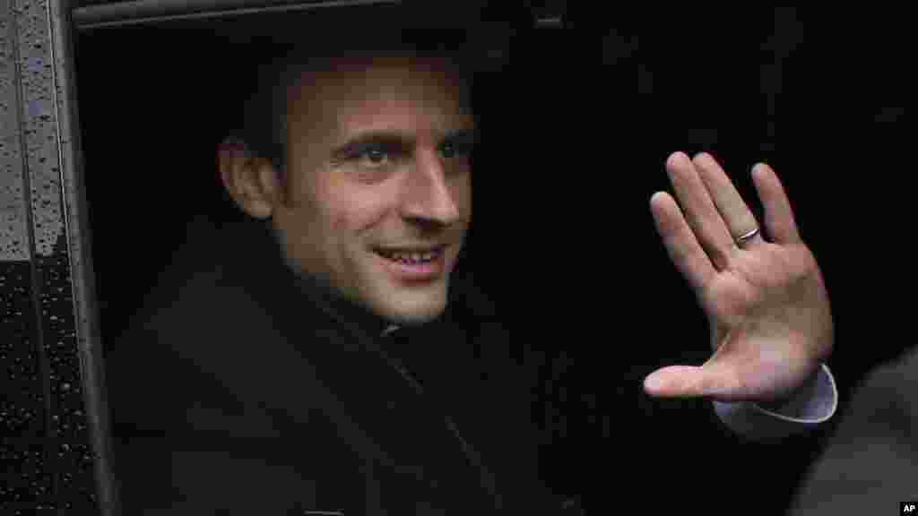 Le candidat de En marche! au second tour de l'élection présidentielle, Emmanuel Macron, salue avant qu'il quitte le bureau de vote.