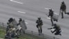 Belarusian riot police detain a demonstrator during an opposition rally to protest the official presidential election results in Minsk, Belarus, Nov. 15, 2020.