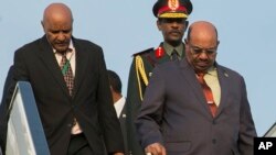 FILE - Sudan President Omar al-Bashir, right, arrives in Kigali, Rwanda, July 16, 2016, to attend an African Union summit. He defied an international warrant of arrest after public assurances from Rwandan leaders that he would not be arrested.