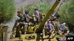TOPSHOT - Afghan resistance movement and anti-Taliban uprising forces are pictured on a Soviet-era tank as they are deployed to patrol along a road in the Astana area of Bazarak in Panjshir province on August 27, 2021, as among the pockets of…