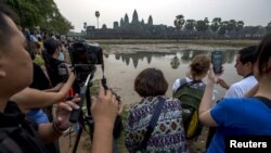 ភ្ញៀវ​ទេសចរ​ប្រមូល​ផ្តុំ​គ្នា​​​ដើម្បី​ថត​រូប​ប្រាសាទ​អង្គរវត្ត​ដ៏​ល្បីល្បាញ​របស់​កម្ពុជា​ក្នុង​អំឡុង​ពេល​ថ្ងៃ​រះ​នៅ​ខេត្ត​សៀមរាប​កាល​ពី​ថ្ងៃ​ទី​២០ ខែ​មីនា ឆ្នាំ​២០១៥។