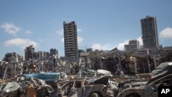 FILE - Damaged cars remain at the site of the Aug. 4 deadly blast in the port of Beirut that killed scores and wounded thousands, in Beirut, Lebanon, Aug. 17, 2020.