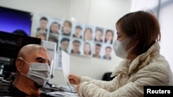 A software engineer tests a facial recognition program that identifies people when they wear a face mask at the development lab of the Chinese electronics manufacturer Hanwang Technology in Beijing as the country is hit by an outbreak of the novel coronav