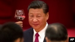 FILE - Chinese President Xi Jinping toasts during a reception at the Great Hall of the People on the eve of the Oct. 1 National Day holiday in Beijing.