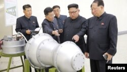 North Korean leader Kim Jong Un, center, provides guidance on a nuclear weapons program in this undated photo released by North Korea's Korean Central News Agency (KCNA) in Pyongyang, Sept. 3, 2017.