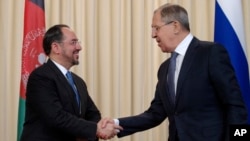 FILE - Russian Foreign Minister Sergey Lavrov, right, and his Afghan counterpart Salahuddin Rabbani shake hands after their meeting in Moscow, Russia, Feb. 7, 2017.