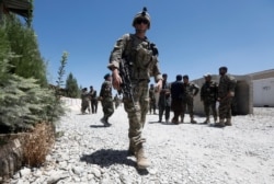 FILE - A U.S. soldier keeps watch at an Afghan National Army base in Logar province, Afghanistan, Aug. 5, 2018.