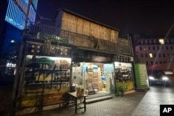 "Fatty Wang's Bookstore" with the words "temporarily closed" spray painted on the glass wall is seen in Ningbo, in eastern China's Zhejiang province, Oct. 9, 2024.