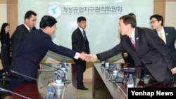 지난해 12월 개성공단 종합지원센터에서 열린 공동위 4차 회의에 앞서 남북한 대표들이 악수하고 있다. (자료사진)