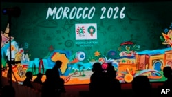 FILE - In this March 17, 2018 file photo, a giant screen displays the logo of Morocco 2026 before a press conference to promote Morocco's bid for the 2026 soccer World Cup in Casablanca, Morocco.