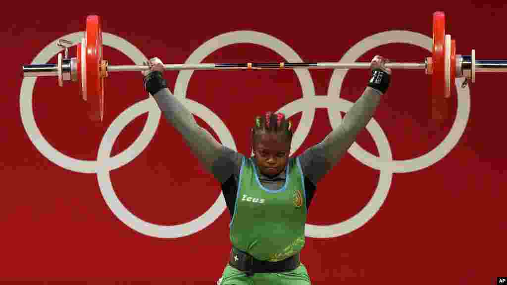 Jeanne Gaelle Eyenga Mboosi of Cameroon competes in the women's 76kg weightlifting event, at the 2020 Summer Olympics, Sunday, Aug. 1, 2021, in Tokyo, Japan. (AP Photo/Luca Bruno)