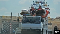 Syrian civilians flee a conflict zone in Syria's rebel-held northwestern region of Idlib, where government bombardment has killed hundreds since late April, near Maar Shurin on the outskirts of Maaret al-Numan, Aug. 22, 2019.