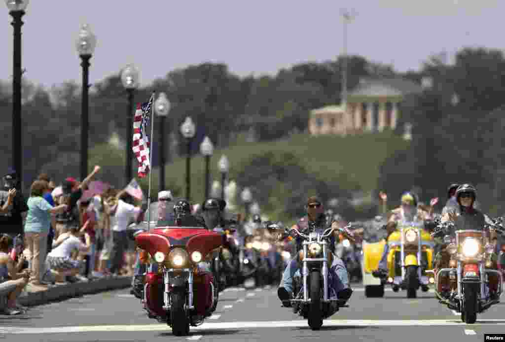 With Arlington National Cemetery as their backdrop, motorcycle riders take part in the 25th annual Rolling Thunder First Amendment Demonstration Run in Washington, May 27, 2012.