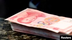 Lembaran uang 100 yuan di sebuah bank di China.