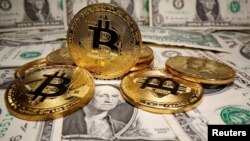 Representaciones de la moneda virtual Bitcoin se colocan en los billetes en dólares estadounidenses en esta ilustración tomada el 26 de mayo de 2020.