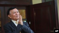 FILE - Cambodia National Rescue Party's President Kem Sokha greets to journalists in his house in Phnom Penh, Cambodia, Nov. 12, 2019. 