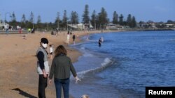 People enjoy the sunshine, as Victoria state begins easing coronavirus disease (COVID-19) restrictions, at Elwood beach in Melbourne, Australia, Sept. 14, 2020.
