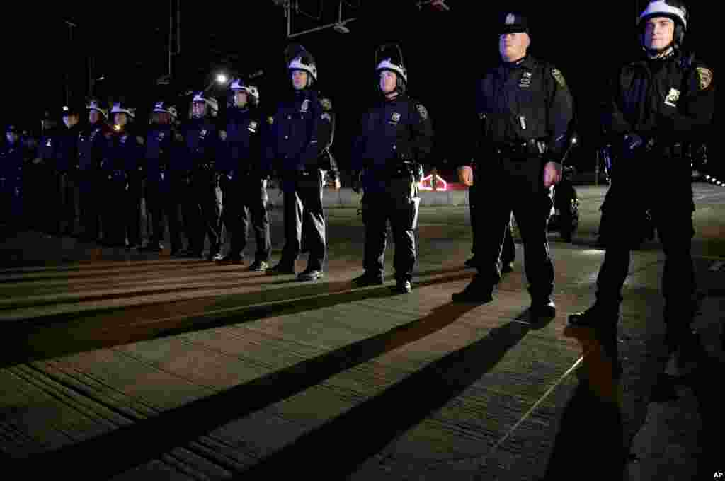 Police officers block protesters from marching up a highway entrance ramp in response to the grand jury's decision in the Eric Garner case in Times Square in New York, Dec. 3, 2014.