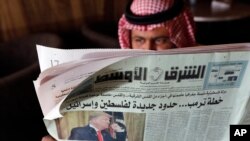 A man holds the daily Asharq Al-Awsat newspaper fronted by a picture of President Donald Trump, at a coffee shop in Jiddah, Saudi Arabia, Jan. 29, 2020. 