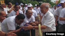 FILE: Prince Norodom Ranariddh, president of FUNCINPEC, is greeted by his supporters during an election campaign in Kampong Cham province on May 20, 2017. (Courtesy photo from a local journalist)