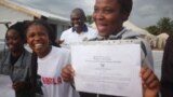 Deux ex-malades d'Ebola devant un centre de traitement après leur guérison, à Beni, RDC, 15 octobre 2018. (VOA/Charly kasereka)