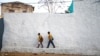Students walk within the walled city of Harar, Ethiopia, Feb. 24, 2017. 