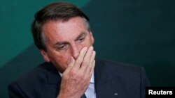 El presidente de Brasil, Jair Bolsonaro, reacciona durante la ceremonia de lanzamiento del Programa Nacional de Crecimiento Verde, en el Palacio Planalto en Brasilia, Brasil, el 25 de octubre de 2021.