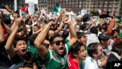 Fans celebrate Mexico's win during the Mexico vs. Germany World Cup football match, as they watched it on an outdoor screen in Mexico City, Mexico, June 17, 2018.