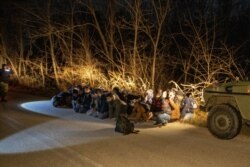 Greek Army soldiers detain a group of migrants that crossed from Turkey to Greece, near the village of Protoklisi, in the region of Evros, Greece, March 10, 2020.