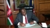 Kenya's President Uhuru Kenyatta invokes article 147(3) of the constitution appointing Deputy President William Ruto as acting President in a ceremony at his office in the capital Nairobi while he attends the ICC status conference at the Hague, Oct. 6, 2014.