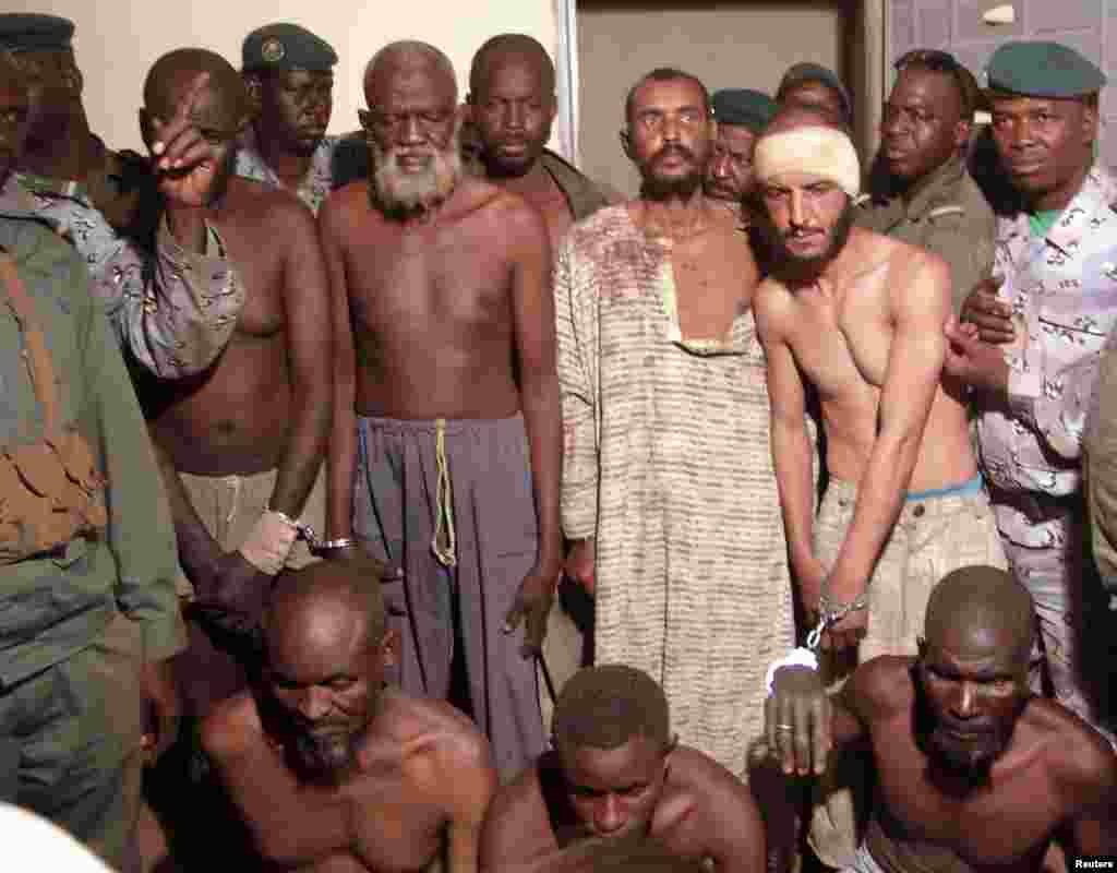 Malian soldiers escort prisoners, who are suspected al-Qaida-allied fighters, in front of a military cell in Mopti, Mali, February 4, 2013.