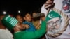 A Bangladeshi man throws a shoe at a Motiur Rahman Nizami poster to celebrate the execution of the Jamaat-e-Islami party's senior leader outside Dhaka's central jail, Bangladesh, early Wednesday, May 11, 2016.