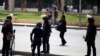 Riot police take their positions near the site of a series of explosions in front of Cairo University April 2, 2014