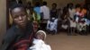Women wait with their babies to be tested for HIV at a hospital in Bududa, eastern Uganda, September 27, 2011. 