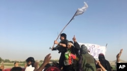 Taliban fighters greet residents in the Surkhroad district of Nangarhar province, east of Kabul, Afghanistan, June 16, 2018. Peace in Afghanistan seems even more elusive, both for troops on the front lines of this war-battered country and for survivors of countless attacks, since the Taliban shrugged off the government’s latest offers of cease-fire and negotiations.