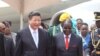 Chinese President Xi Jinping, right, and Zimbabwean President Robert Mugabe hold hands upon his arrival in Harare, Zimbabwe, Tuesday, Dec. 1. 2015.