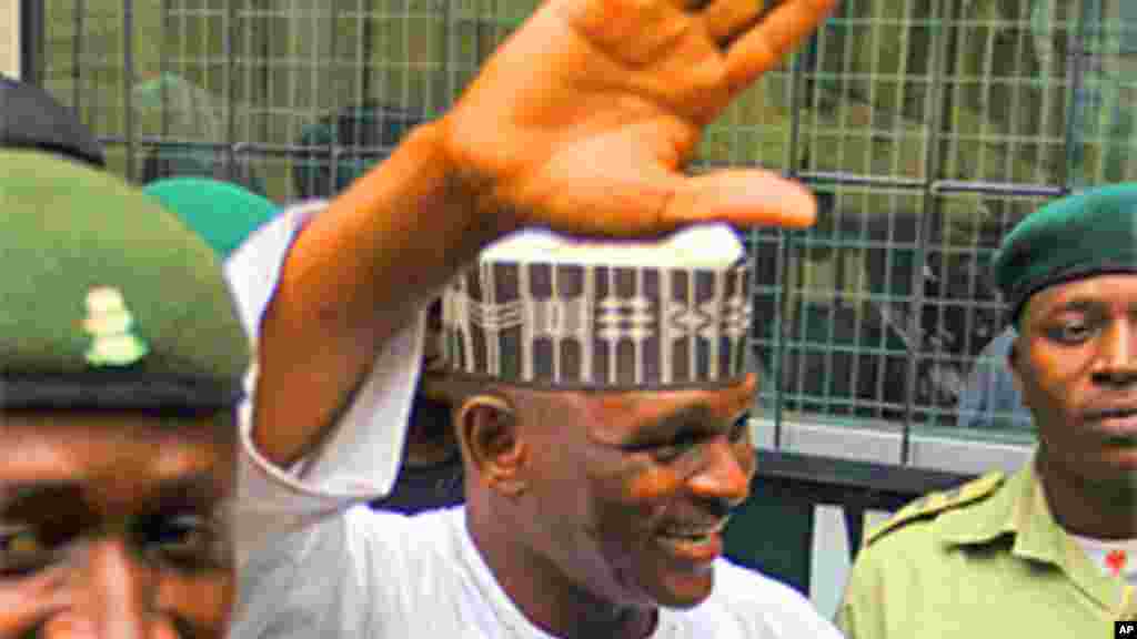 Hamza Al-Mustapha, the former chief security officer to Nigeria's late military ruler Sani Abacha, is escorted by prison officials as he leaves the Lagos high court at Igbosere district.