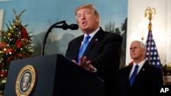 Vice President Mike Pence listens as President Donald Trump speaks at the White House to officially recognizes Jerusalem as the capital of Israel, Wednesday, Dec. 6, 2017. (AP Photo/Evan Vucci)